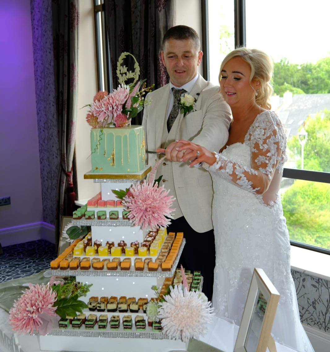A couple cutting their wedding fudge display